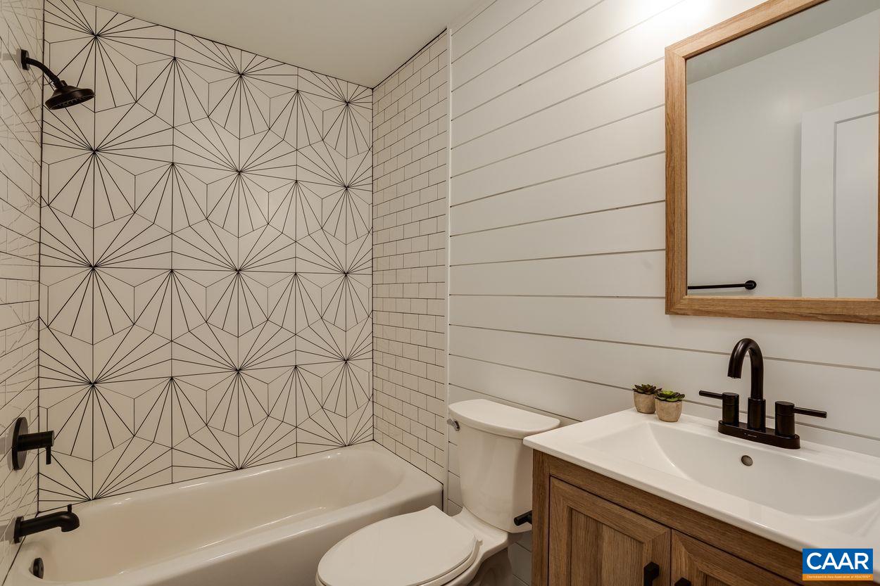 321 Gillums Ridge Road Charlottesville, VA 22903 - Photo 42 of 61 a bathroom with a sink a toilet and shower