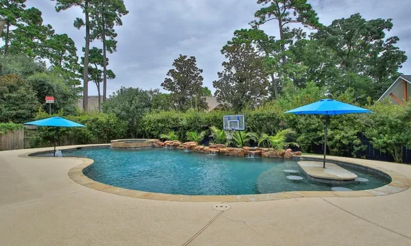 a view of a swimming pool and lounge chairs