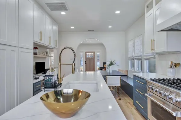 a large kitchen with a large window and stainless steel appliances