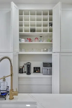a view of white cabinets and a window