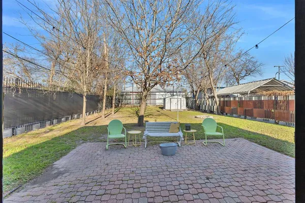 a view of backyard with swimming pool and seating space