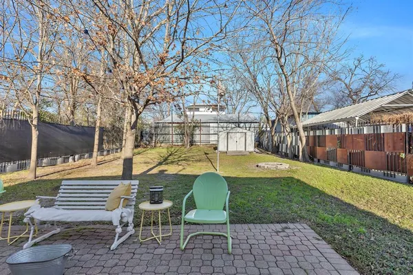a view of a house with backyard and chairs