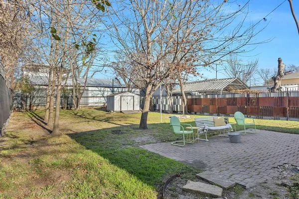 a view of house with backyard and seating area