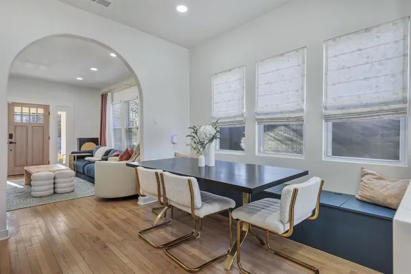 a dining room with furniture and wooden floor