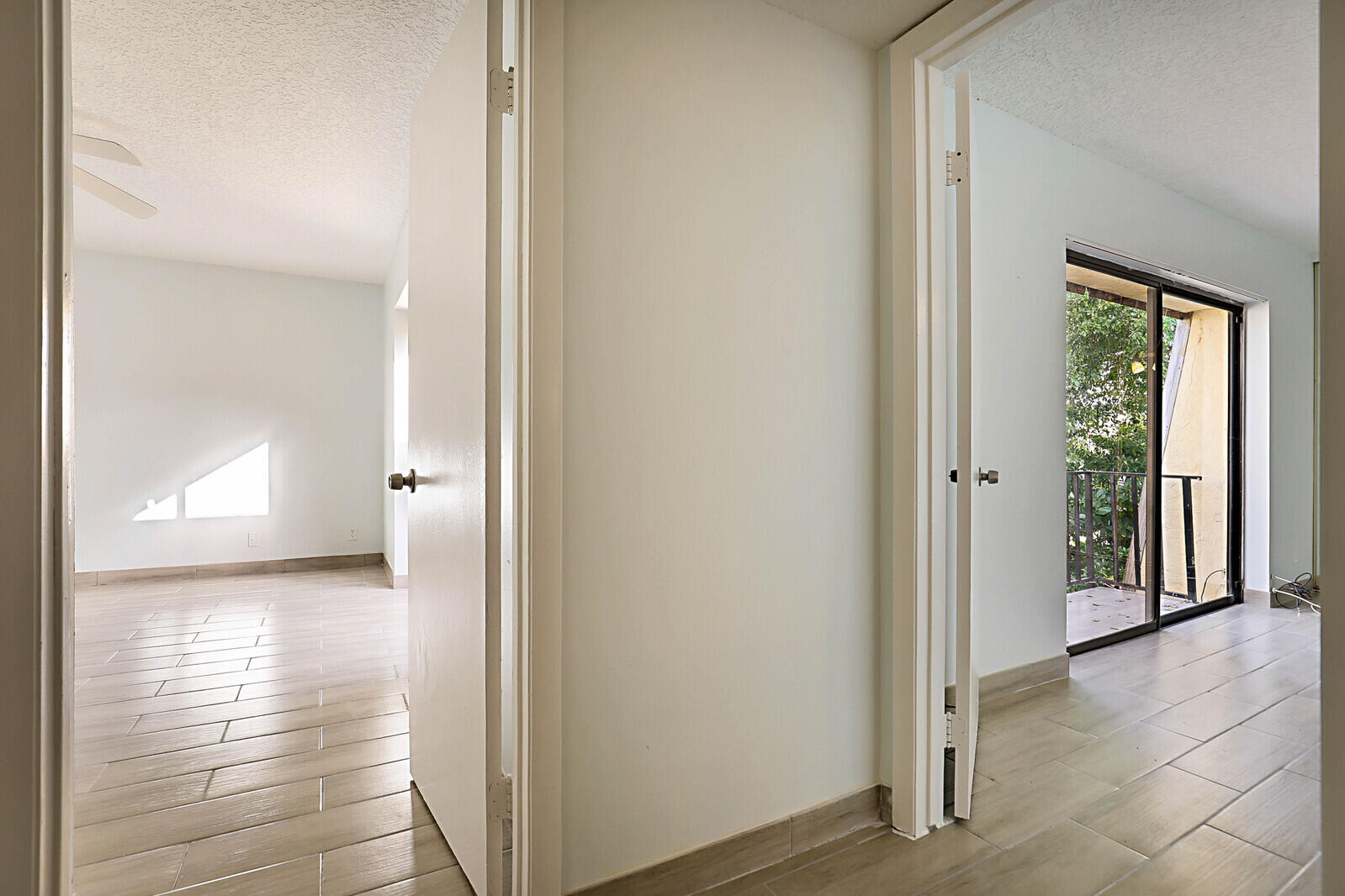 253 Woodland Road Palm Springs, FL 33461 - Photo 18 of 27 a view of a hallway with wooden floor and a room