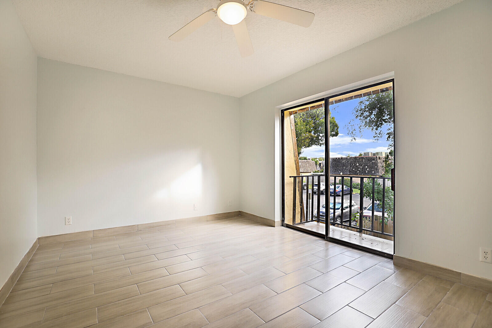 253 Woodland Road Palm Springs, FL 33461 - Photo 26 of 27 a view of an empty room with wooden floor and a window
