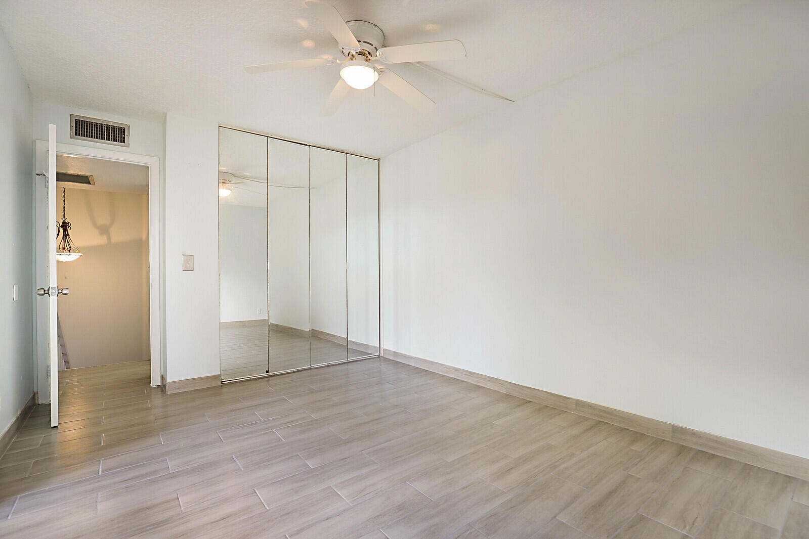 253 Woodland Road Palm Springs, FL 33461 - Photo 27 of 27 wooden floor in an empty room