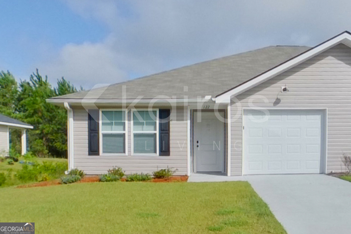 122 Cottage Grove Road Brunswick, GA 31525 - Photo 1 of 20 a front view of a house with a yard