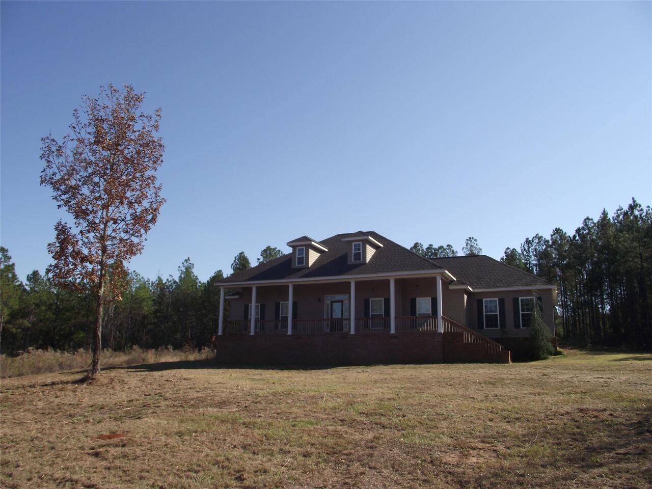 1257 Old Toomsboro Road Dublin, GA 31021 - Photo 1 of 1 a front view of a house with a yard