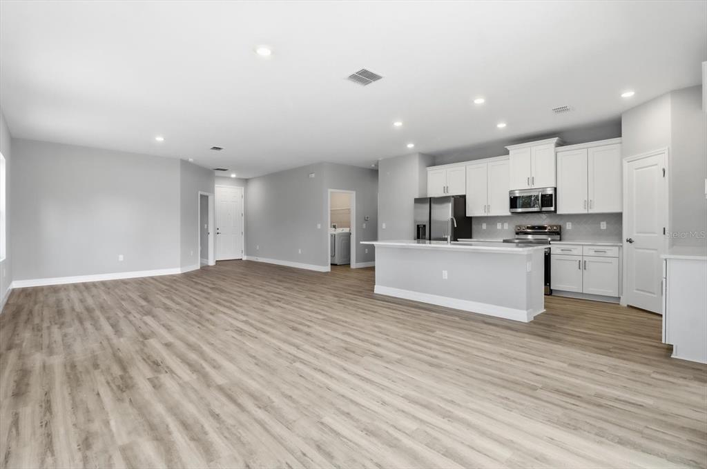 16604 Southwest 21st Circle Ocala, FL 34473 - Photo 8 of 43 a view of kitchen with wooden floor and electronic appliances