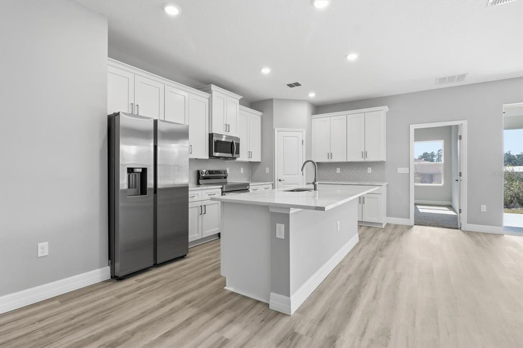 16604 Southwest 21st Circle Ocala, FL 34473 - Photo 9 of 43 a large kitchen with a sink stainless steel appliances and cabinets