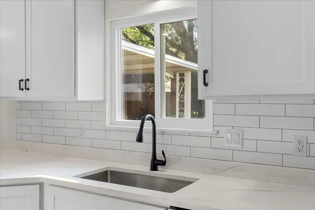 a bathroom with a sink and a window