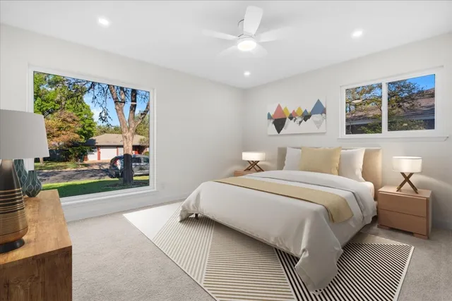 a spacious bedroom with a bed a couch and a window