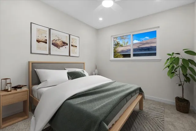 a bedroom with bed and wall painting