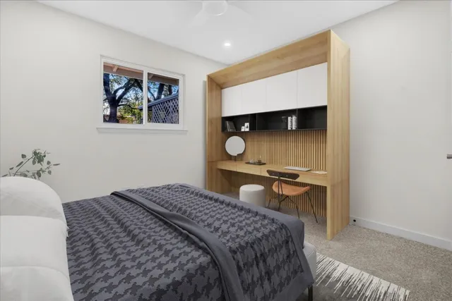 a bedroom with a bed and a painting on the wall