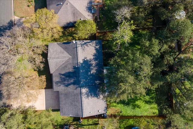 an aerial view of a house with a yard