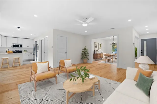 a living room with furniture and kitchen view