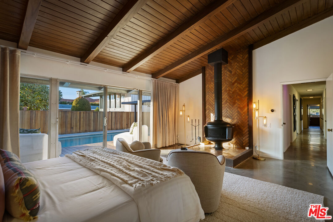 9440 Gallatin Road Downey, CA 90240 - Photo 29 of 55 a bedroom with a bed a chandelier and large window