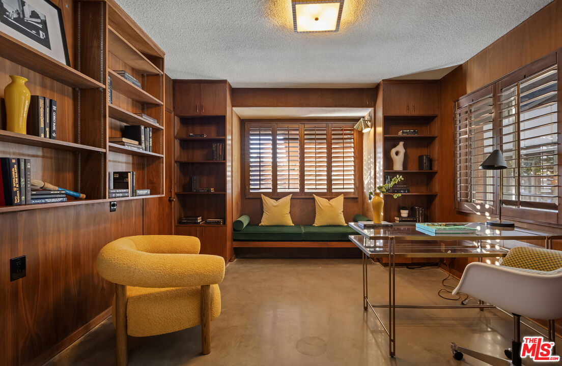 9440 Gallatin Road Downey, CA 90240 - Photo 38 of 55 a living room with furniture and a book shelf