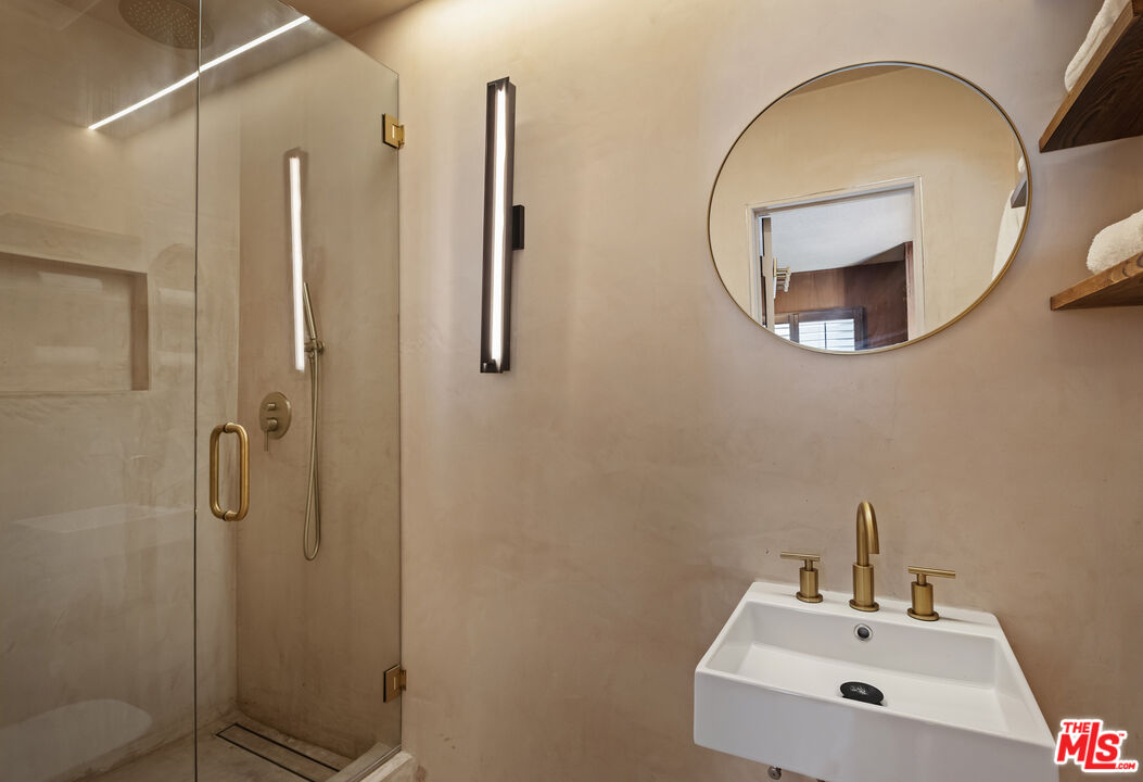 9440 Gallatin Road Downey, CA 90240 - Photo 40 of 55 a bathroom with a sink a mirror and a shower