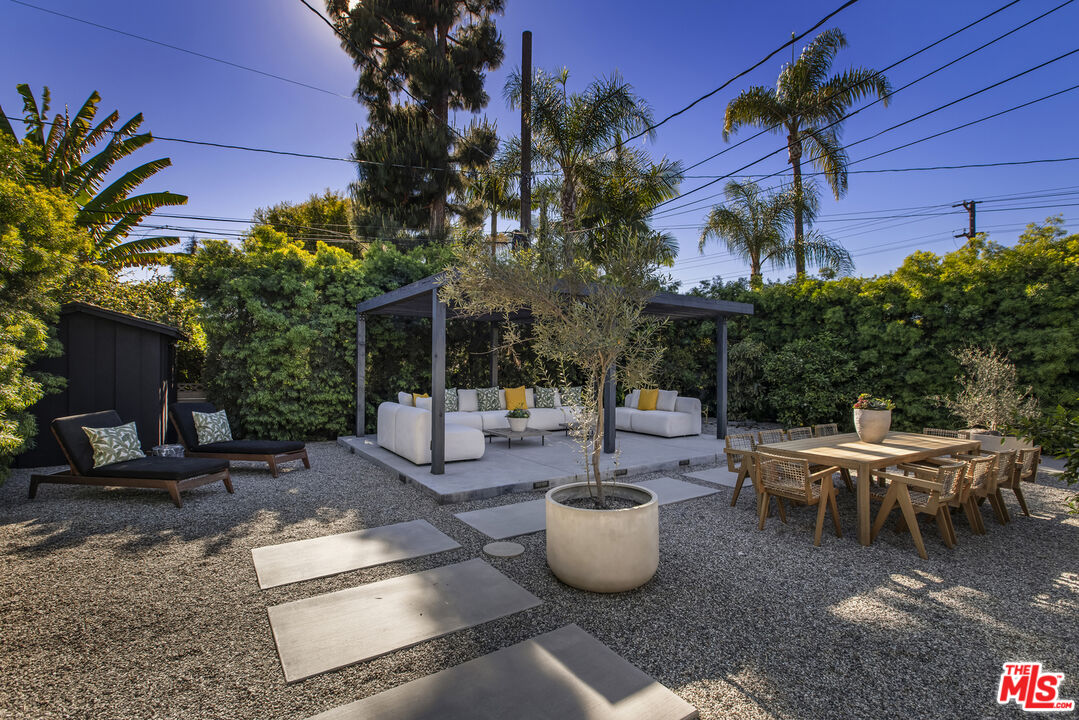 9440 Gallatin Road Downey, CA 90240 - Photo 47 of 55 a view of a backyard with table and chairs and potted plants