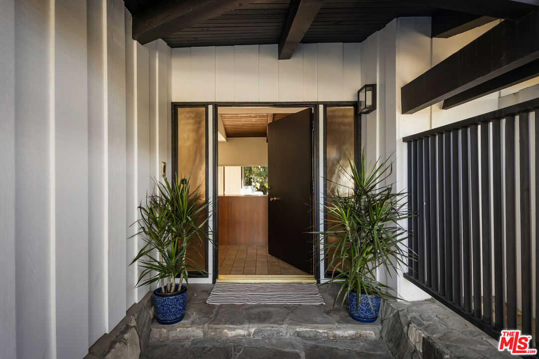 9440 Gallatin Road Downey, CA 90240 - Photo 7 of 55 a potted plant is sitting in front of a door