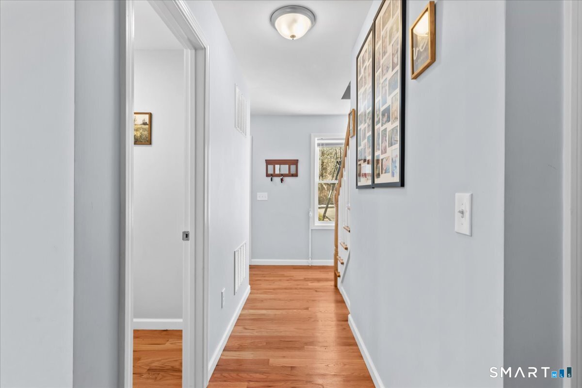 26 2nd Street Lebanon, CT 06249 - Photo 13 of 37 a view of a hallway with wooden floor and staircase