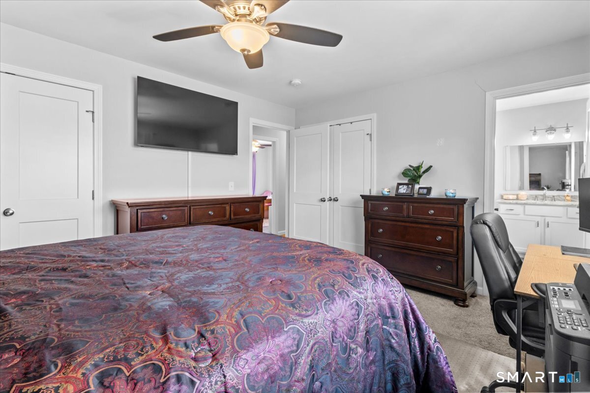 26 2nd Street Lebanon, CT 06249 - Photo 19 of 37 a bedroom with a bed and a flat screen tv