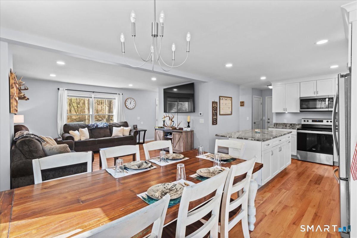26 2nd Street Lebanon, CT 06249 - Photo 4 of 37 a large white kitchen with lots of counter space dining table and stainless steel appliances