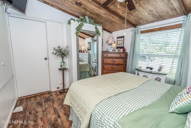 a bedroom with a bed and a dresser