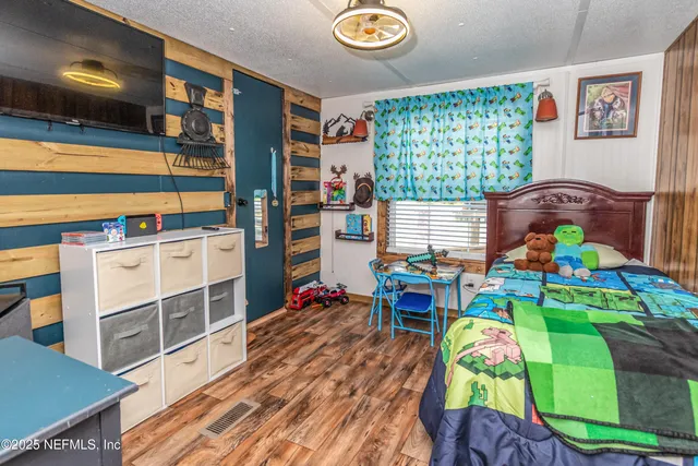 a bedroom with furniture and a window