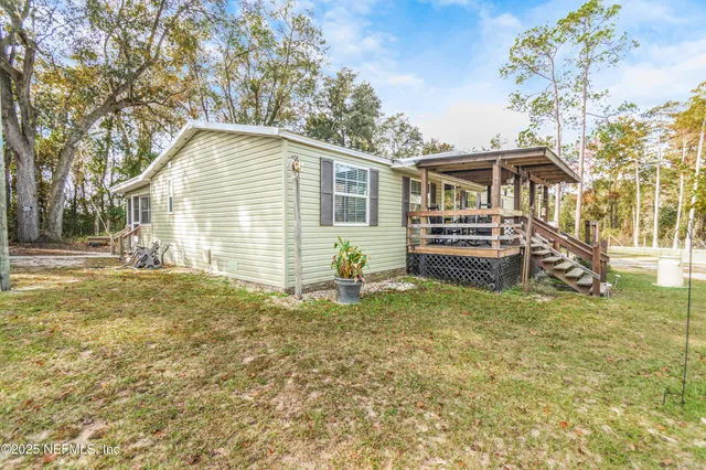 a backyard of a house with barbeque oven