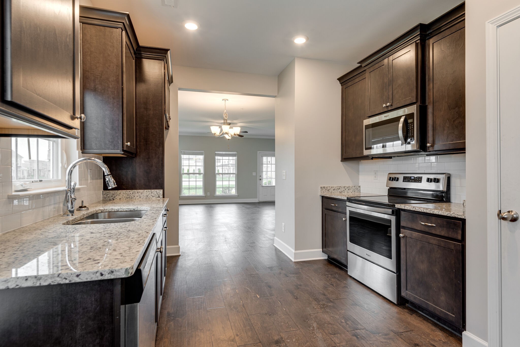 269 Mary Ann Circle Spring Hill, TN 37174 - Photo 10 of 28 a kitchen with granite countertop stainless steel appliances and wooden floor
