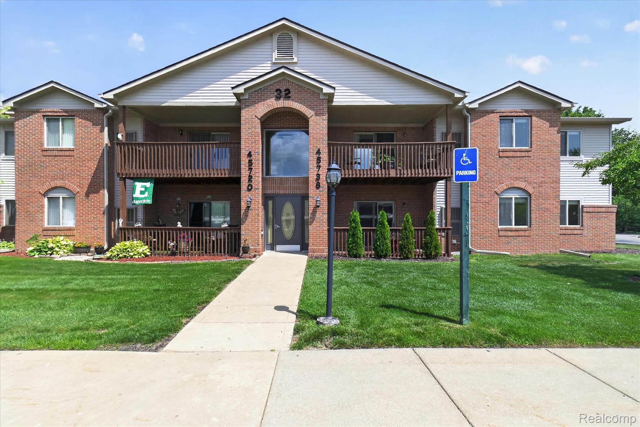 45720 Prairiegrass Court Belleville, MI 48111 - Photo 1 of 31 Brick facade building featuring multiple balconies