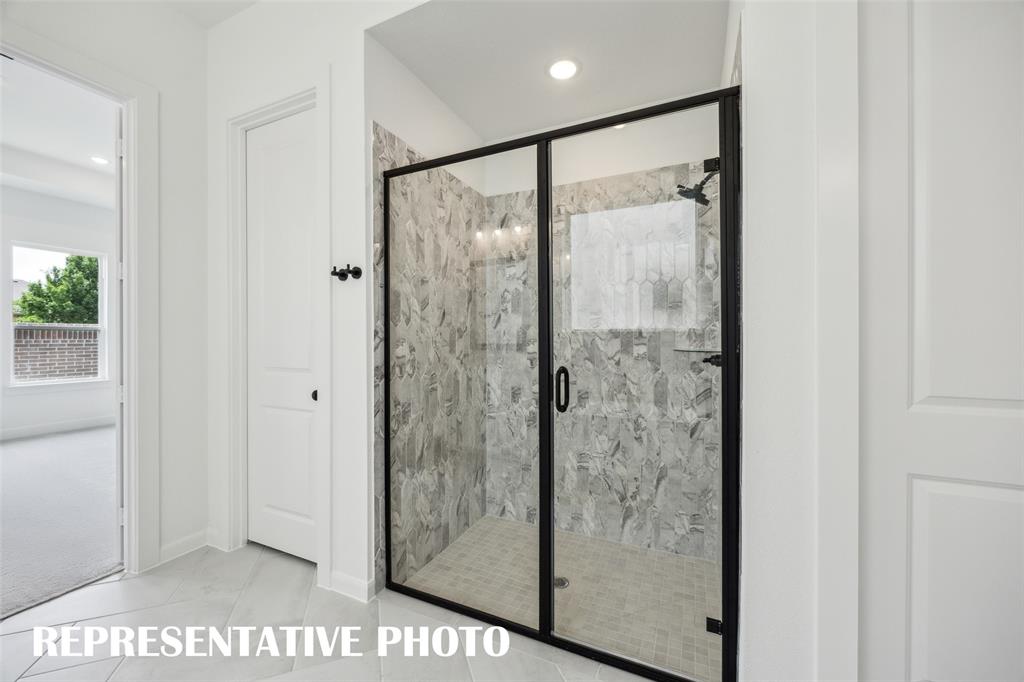 9530 Keep Street Frisco, TX 75035 - Photo 10 of 18 a bathroom with a glass shower door
