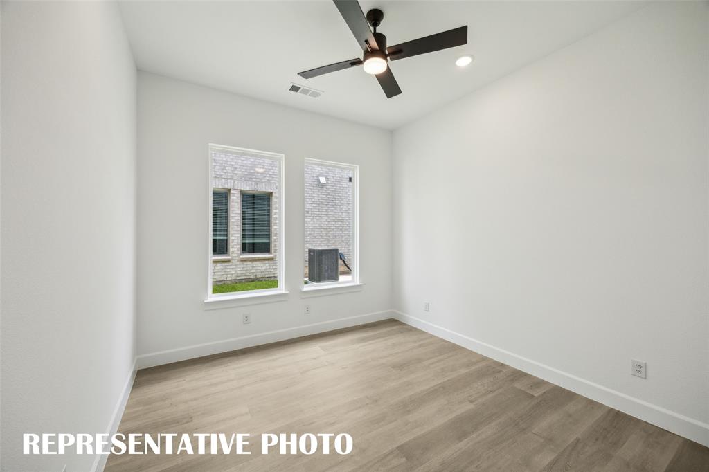9530 Keep Street Frisco, TX 75035 - Photo 12 of 18 an empty room with a ceiling fan and window