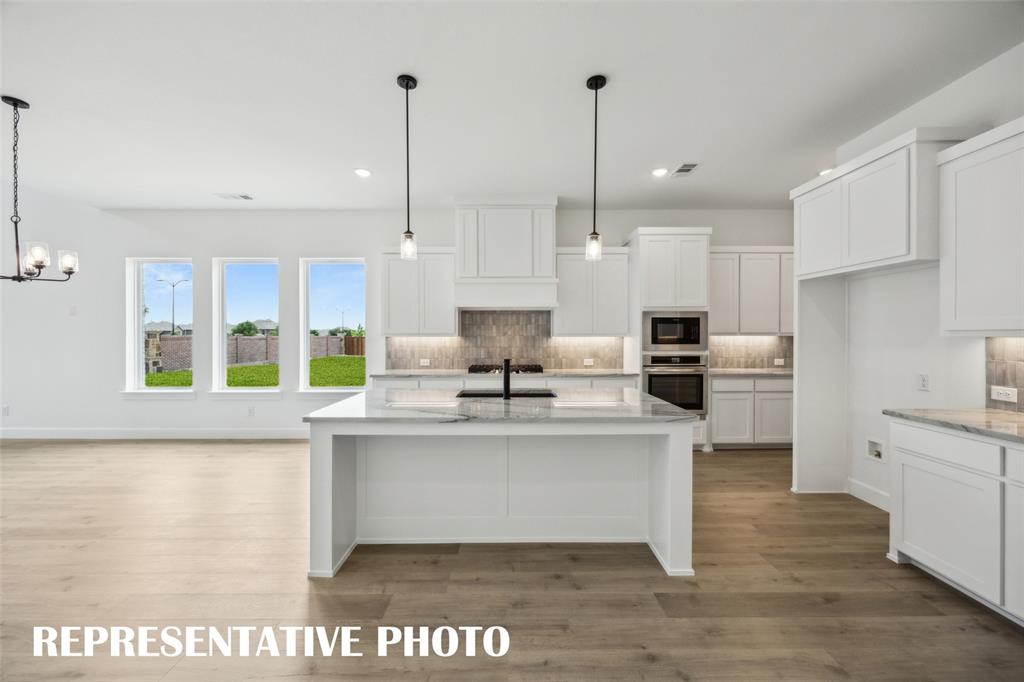 9530 Keep Street Frisco, TX 75035 - Photo 3 of 18 a view of kitchen with stainless steel appliances granite countertop stove top oven and cabinets
