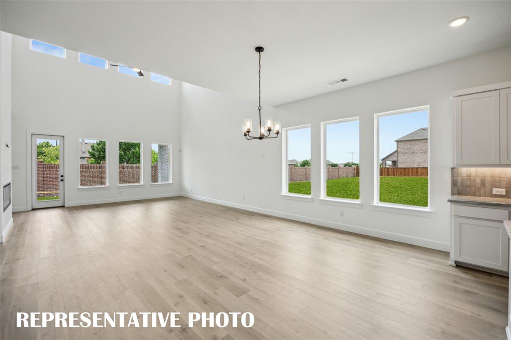 9530 Keep Street Frisco, TX 75035 - Photo 5 of 18 a view of an empty room with a window and wooden floor