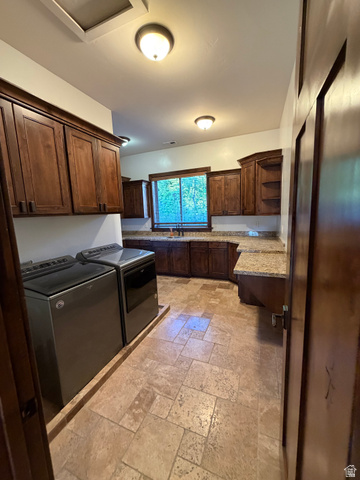 4536 North 475 East Provo, UT 84604 - Photo 34 of 65 Utility room featuring extensive wood cabinetry, granite-finish countertops, tiled flooring, built-in sink, and overhead lighting