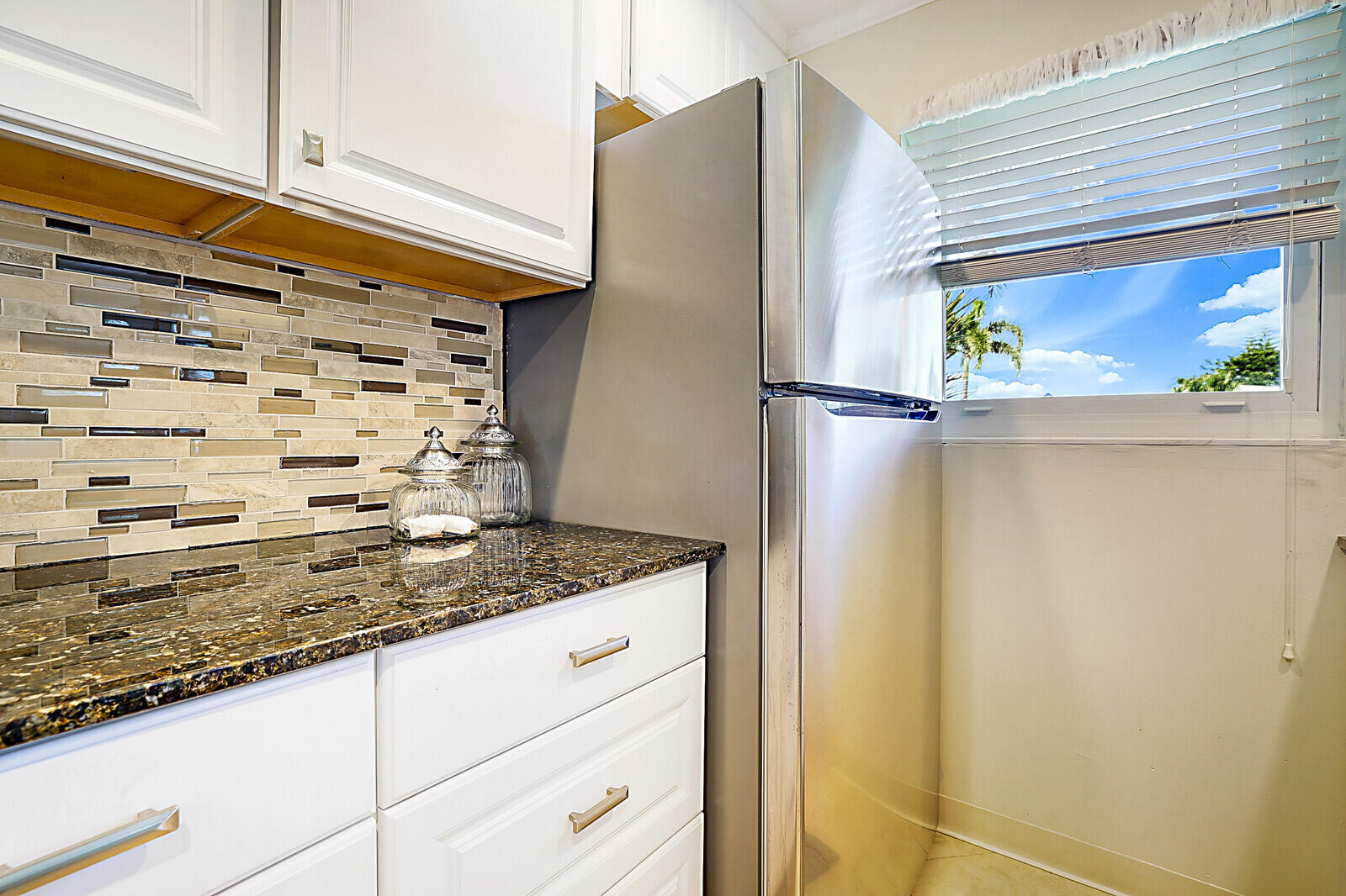 170 High Point Boulevard, Unit B Boynton Beach, FL 33435 - Photo 15 of 26 a bathroom with a granite countertop window and a shower