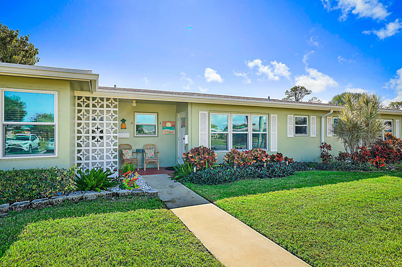 170 High Point Boulevard, Unit B Boynton Beach, FL 33435 - Photo 22 of 26 a front view of a house with garden