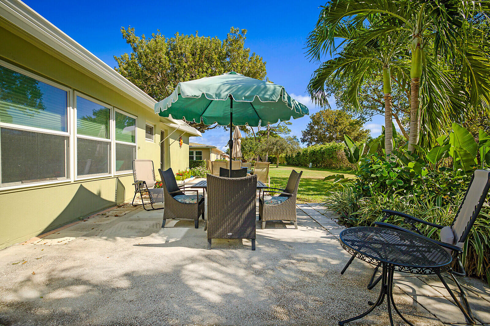 170 High Point Boulevard, Unit B Boynton Beach, FL 33435 - Photo 24 of 26 a view of a chairs and table in backyard