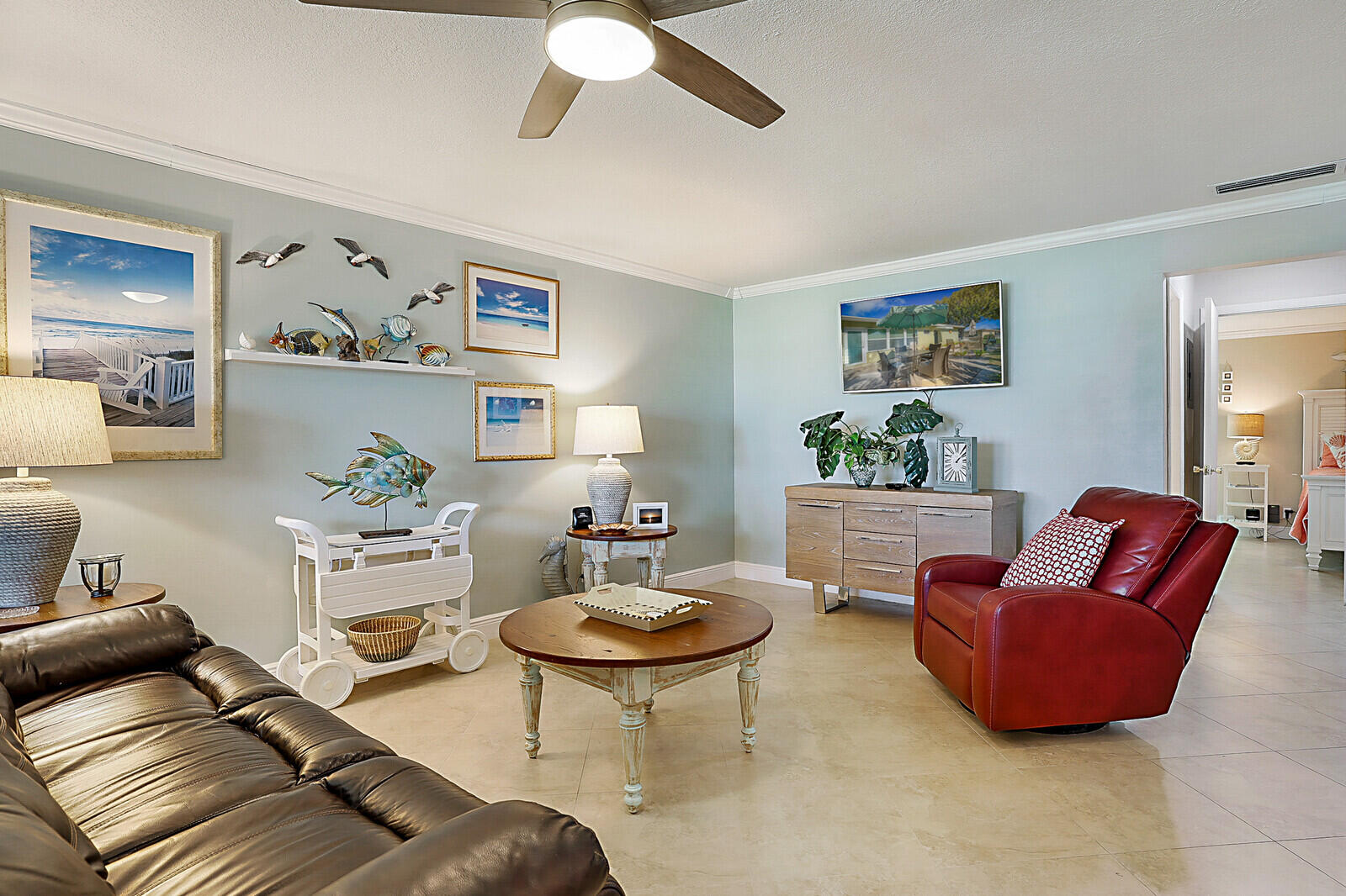 170 High Point Boulevard, Unit B Boynton Beach, FL 33435 - Photo 6 of 26 a living room with furniture a rug and wall paintings