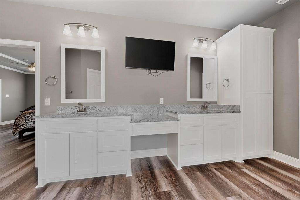 634 Gant Road Sherman, TX 75090 - Photo 21 of 40 Double vanity with white cabinetry, light granite countertops, and two undermount sinks