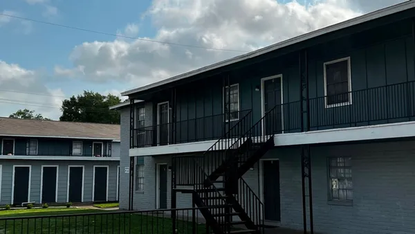 a backyard of a house with table and chairs