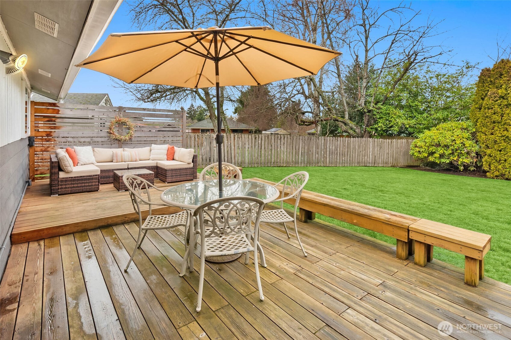 4726 South Victor Street Seattle, WA 98178 - Photo 23 of 30 a view of a roof deck with table and chairs under an umbrella