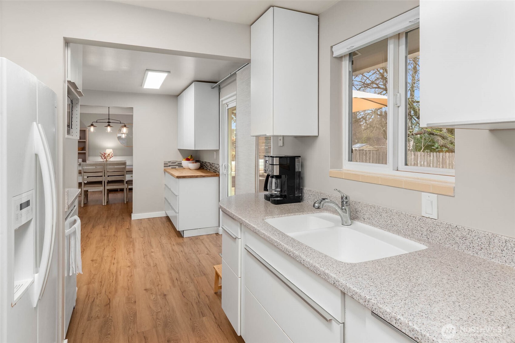 4726 South Victor Street Seattle, WA 98178 - Photo 6 of 30 a kitchen with granite countertop a sink stove and refrigerator