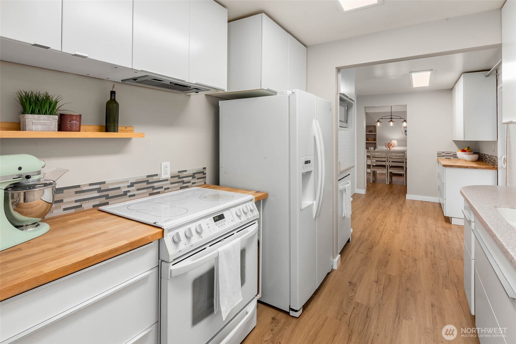 4726 South Victor Street Seattle, WA 98178 - Photo 7 of 30 a kitchen with a stove and wooden floor