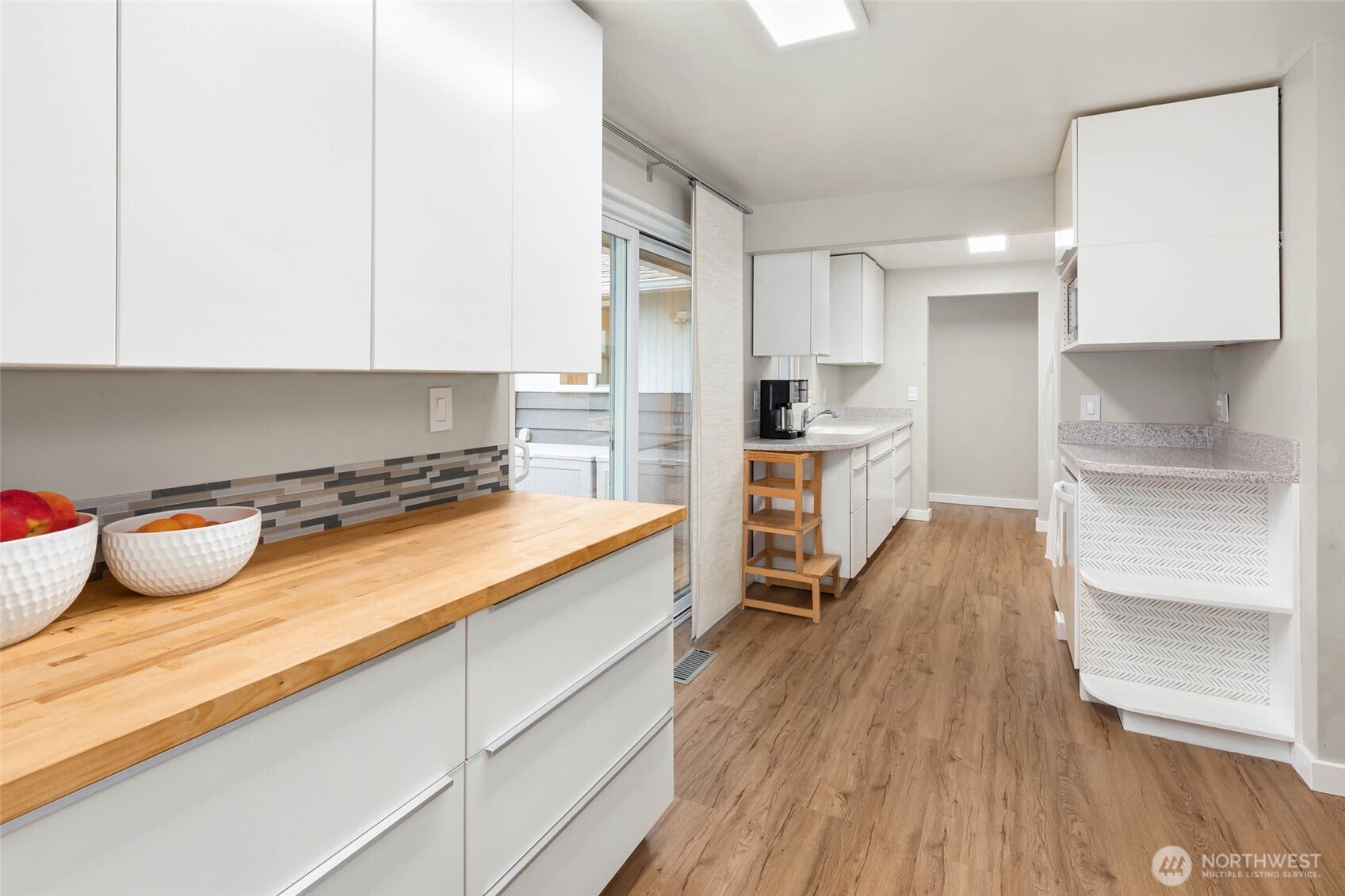 4726 South Victor Street Seattle, WA 98178 - Photo 8 of 30 a kitchen with kitchen island wooden floors and appliances
