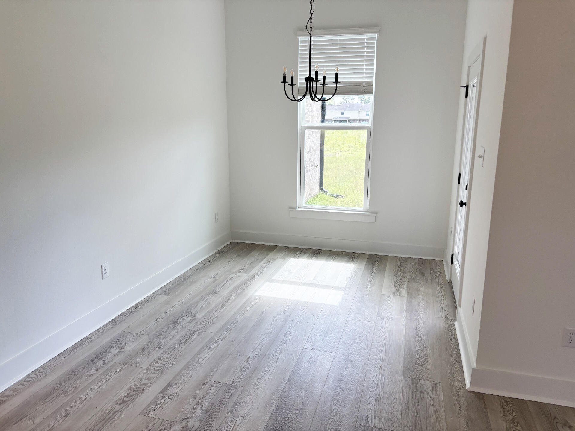 5800 Del Rio Crossing Crestview, FL 32539 - Photo 8 of 24 an empty room with wooden floor and windows